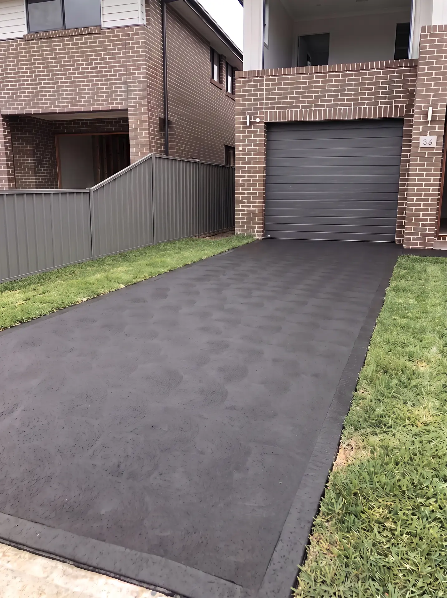 Finished charcoal cove finish concrete driveway after replacement